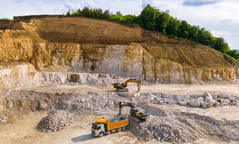 Trucks excavating mining resources