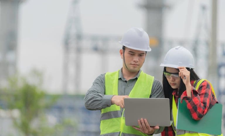 Two field workers observing data remotely