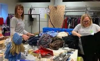 Qualitrol volunteers sorting donated clothes at the distribution center