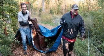 Qualitrol volunteers cleaning a natural area and picking up trash