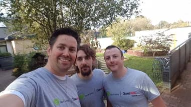 Three Qualitrol volunteers taking a selfie during a volunteer activity