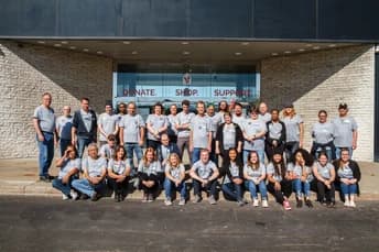 Large group of Qualitrol volunteers in front of the building during Global Day of Caring