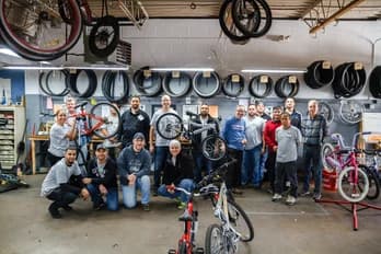 Qualitrol volunteer team with bicycles repaired for donation